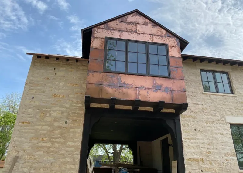Copper metal panel facade on a stone building for Metal Roof Coating in Lockwood